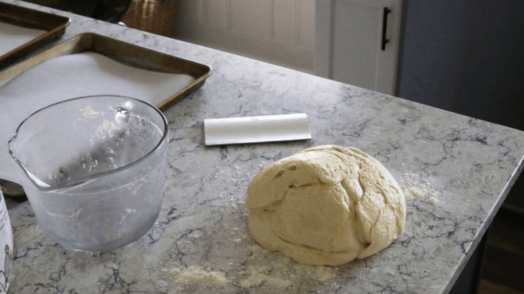 soft sourdough hamburger bun dough on counter