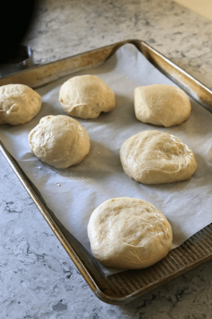 soft sourdough hamburger buns dough pressed down