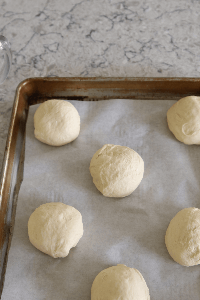 soft sourdough hamburger buns dough on a cookie sheet formed buns