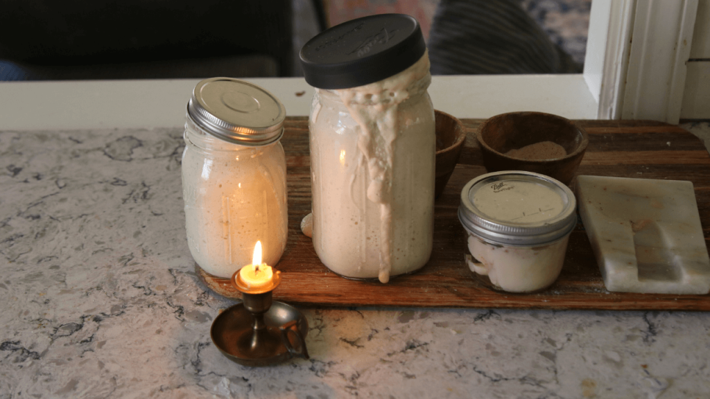 sourdough starter running over with beeswax candle