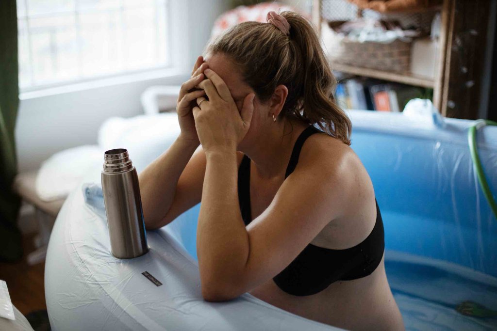 Woman in labor in birth tub