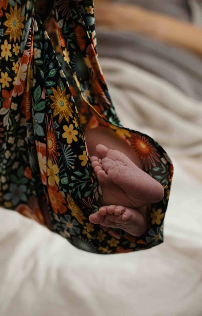 Newborn baby feet showing baby being weighed after birth