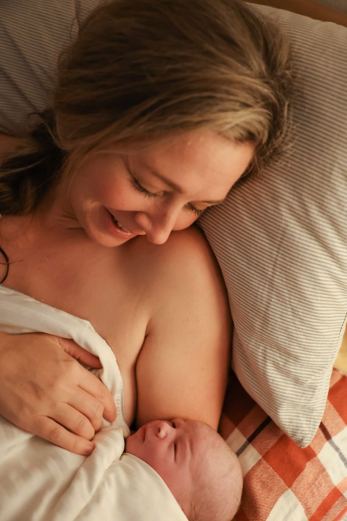 Woman in bed with new born baby