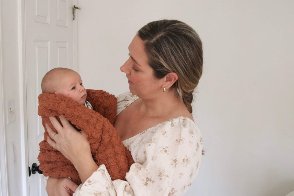 Mom wearing Neuflora dress with baby postpartum