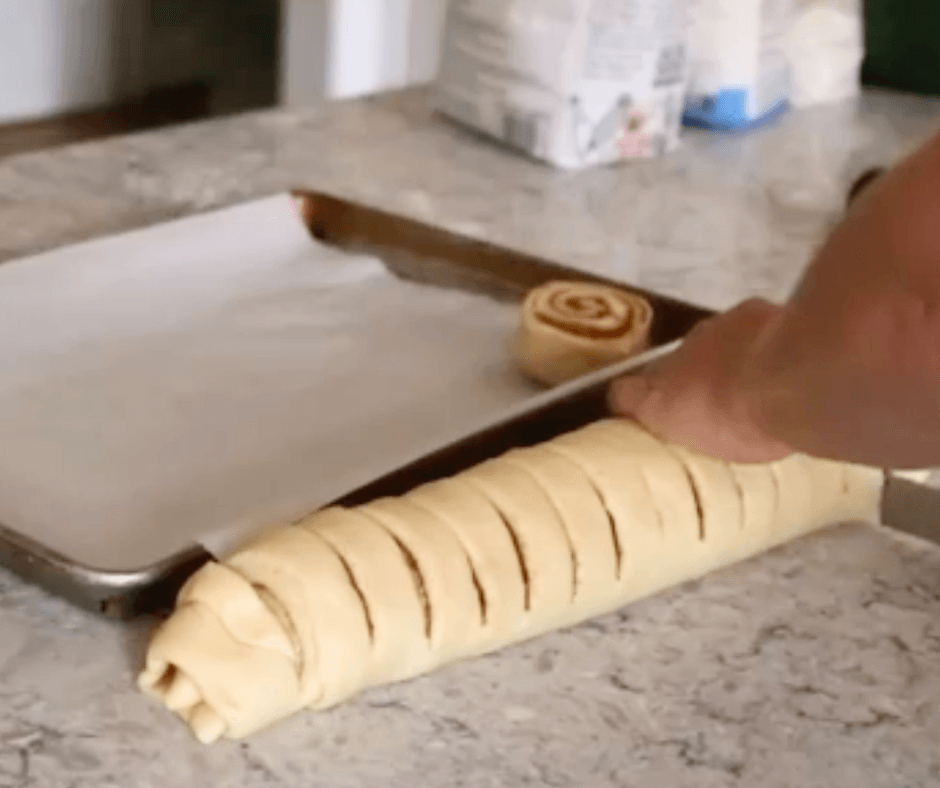 cutting cinnamon rolls