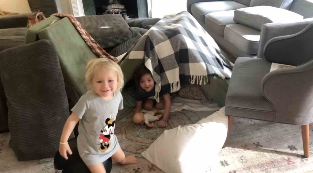 kids playing in a homemade fort