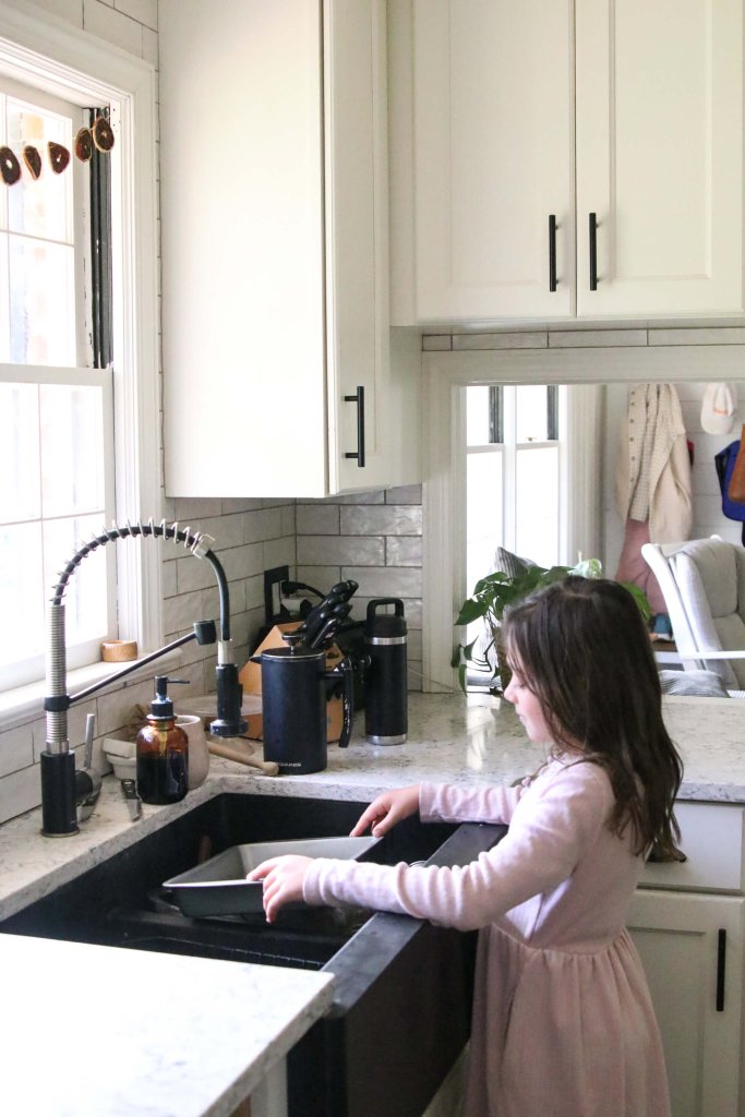 Little girl doing dishes