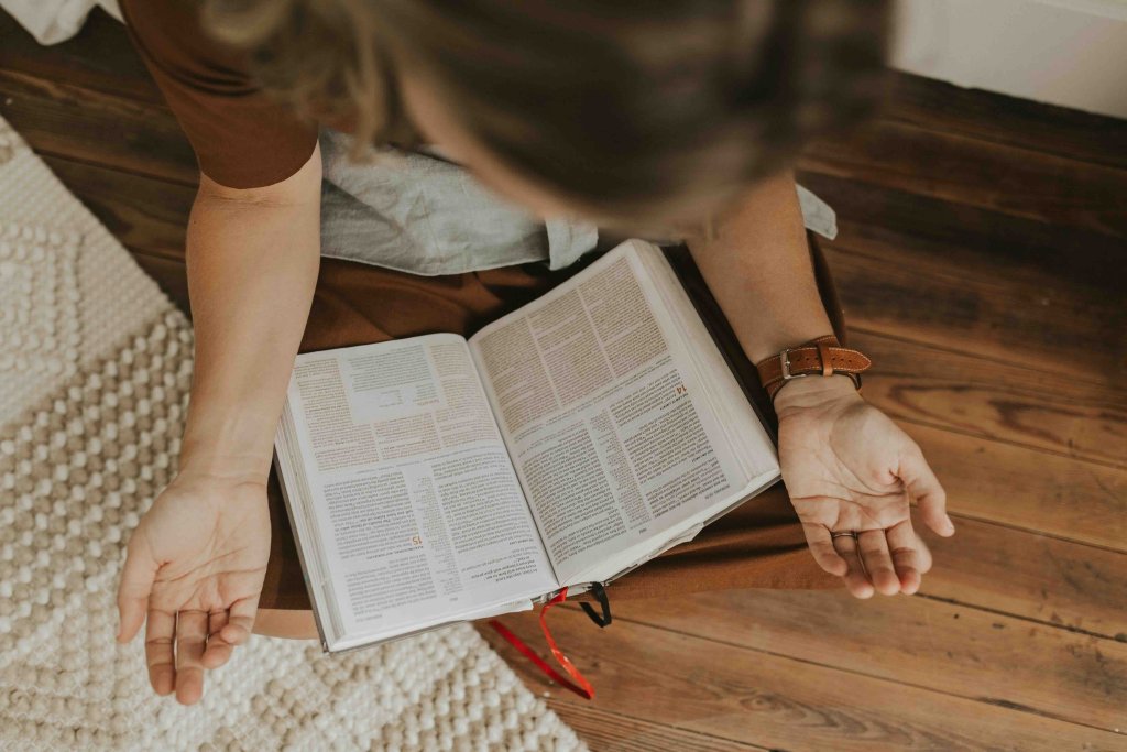 Lana with a Bible praying