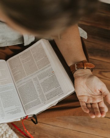 Lana praying with Bible