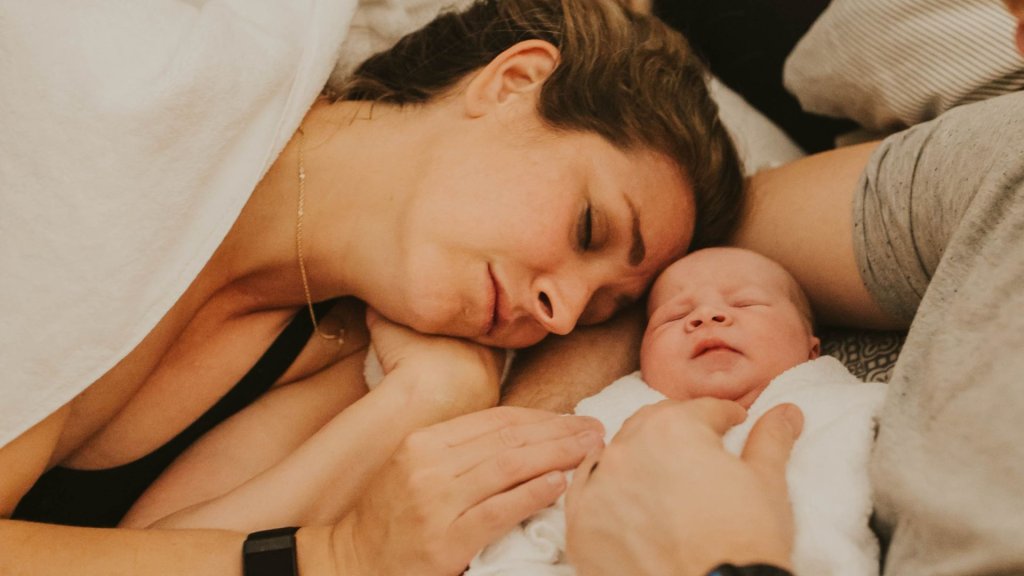 Lana laying next to new baby