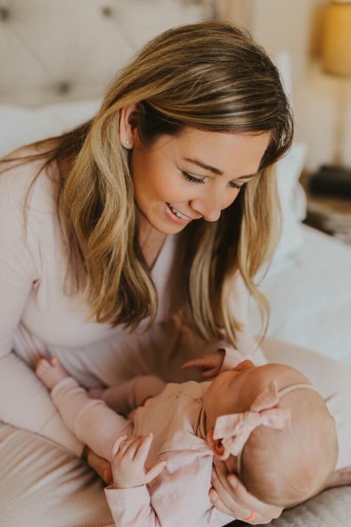 Lana with baby on bed