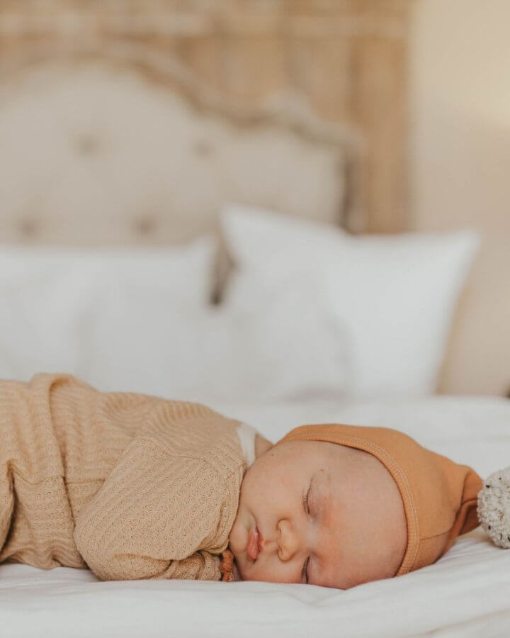 baby sleeping on the bed